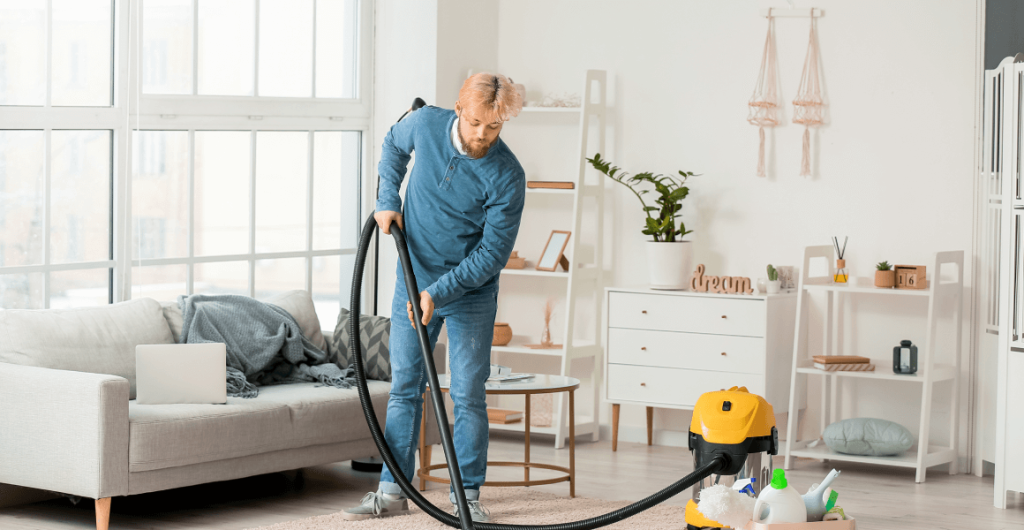 young-man-hoovering-carpet-home 3