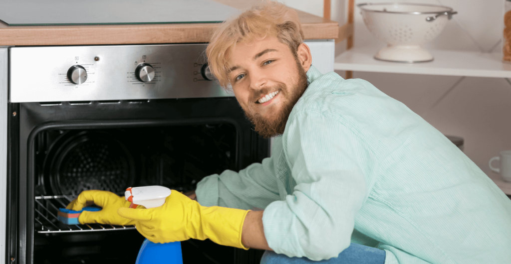 young-man-cleaning-oven-kitchen 1